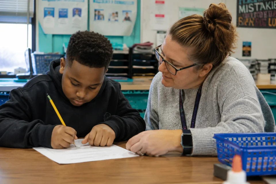 Teacher Assistant working with student