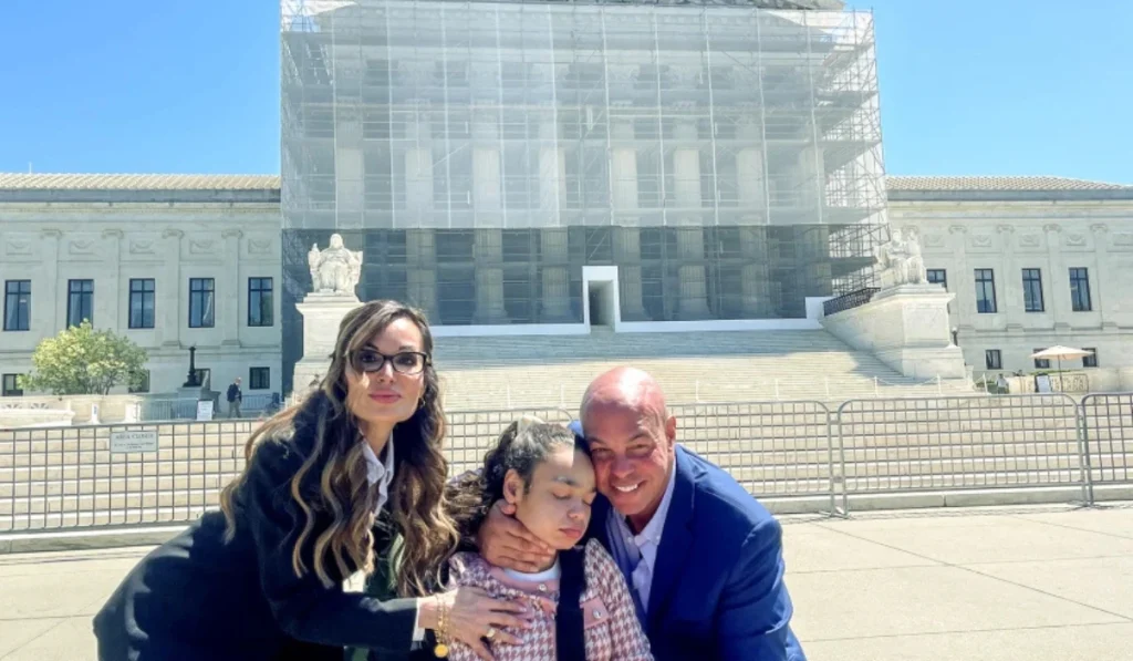 Gina and Aaron Tharpe appear outside the U.S. Supreme Court on April 28 with their daughter Ava, who has a severe form of epilepsy